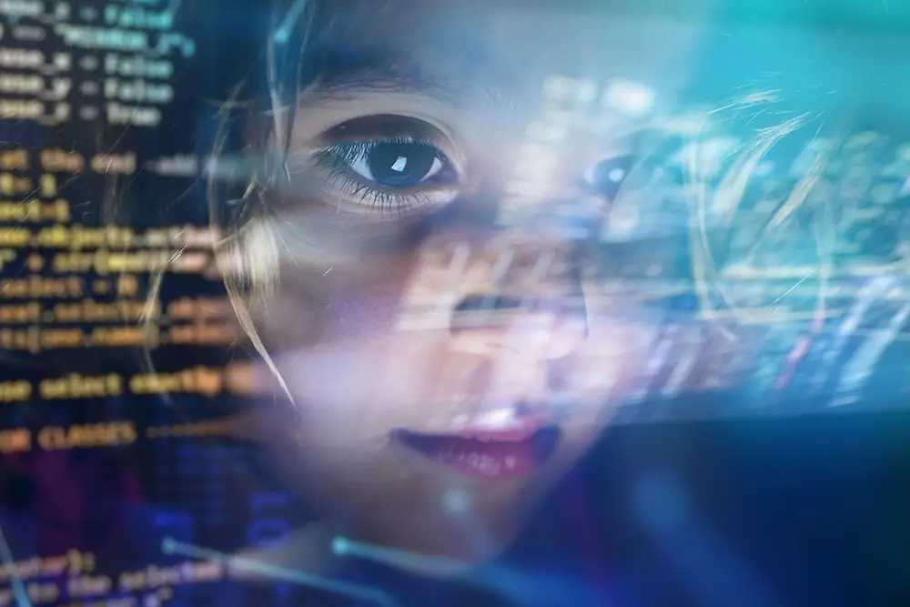 Digital code overlaid on a child's face, representing online risk awareness
